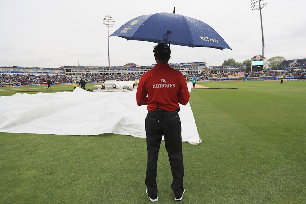 Kumar Dharamsena watches the covers being unfolded, Australia v New Zealand, Champions Trophy, Group A, Edgbaston, June 2, 2017