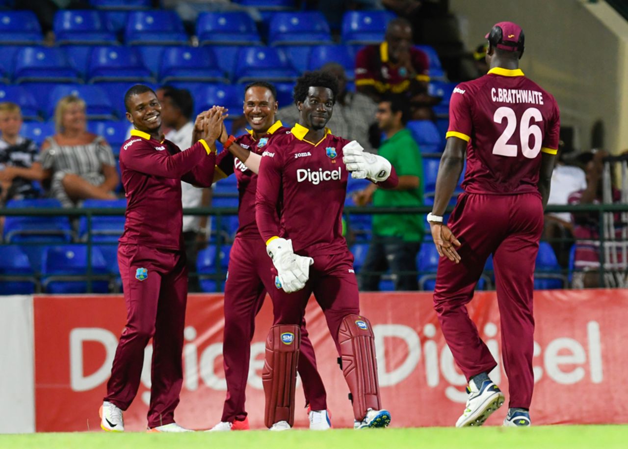 The West Indies players converge to celebrate the dismissal of Karim Janat, West Indies v Afghanistan, 3rd T20I, St Kitts, June 5, 2017