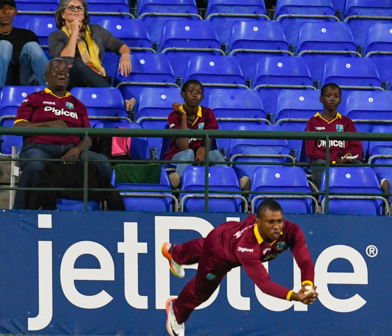 Spectators watch in anticipation as Evin Lewis puts in a forward dive to snaffle a low grab, West Indies v Afghanistan, 3rd T20I, St Kitts, June 5, 2017