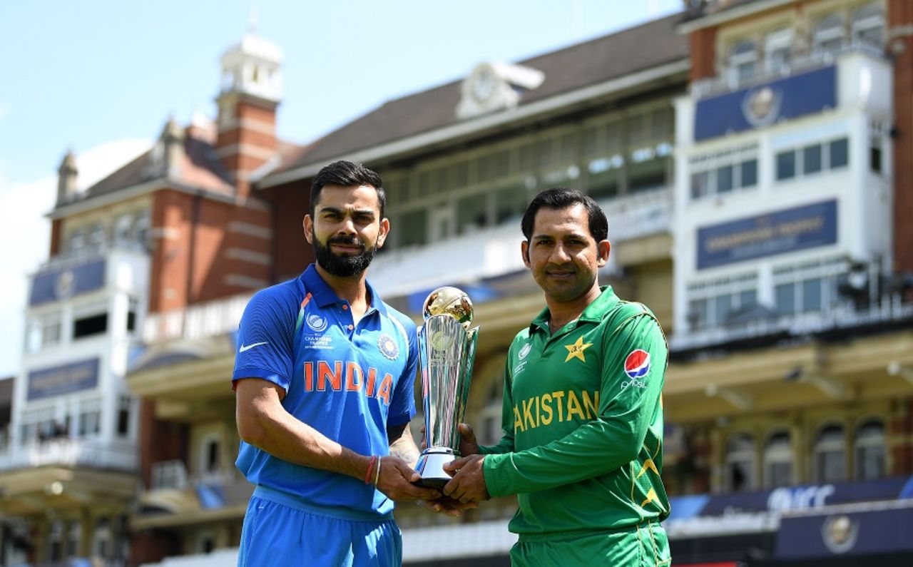 The captains Virat Kohli and Sarfraz Ahmed pose with the Champions Trophy in front of the famed pavillion at The Oval, London, June 17, 2017