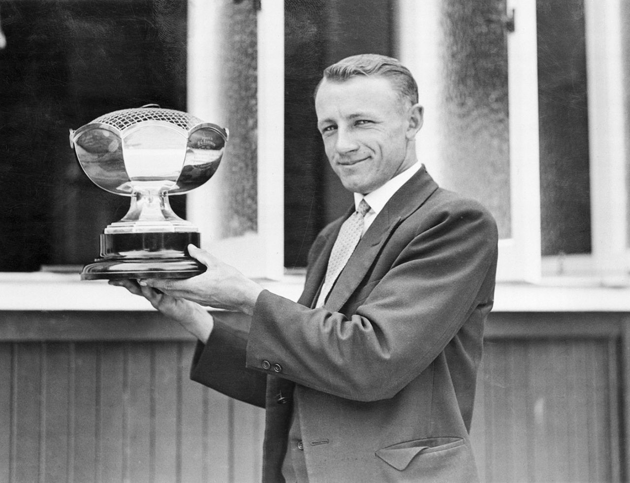 Donald Bradman holds up a trophy he received, before sailing on the Ashes tour, for his world-record 452 earlier in the season, March 31, 1930