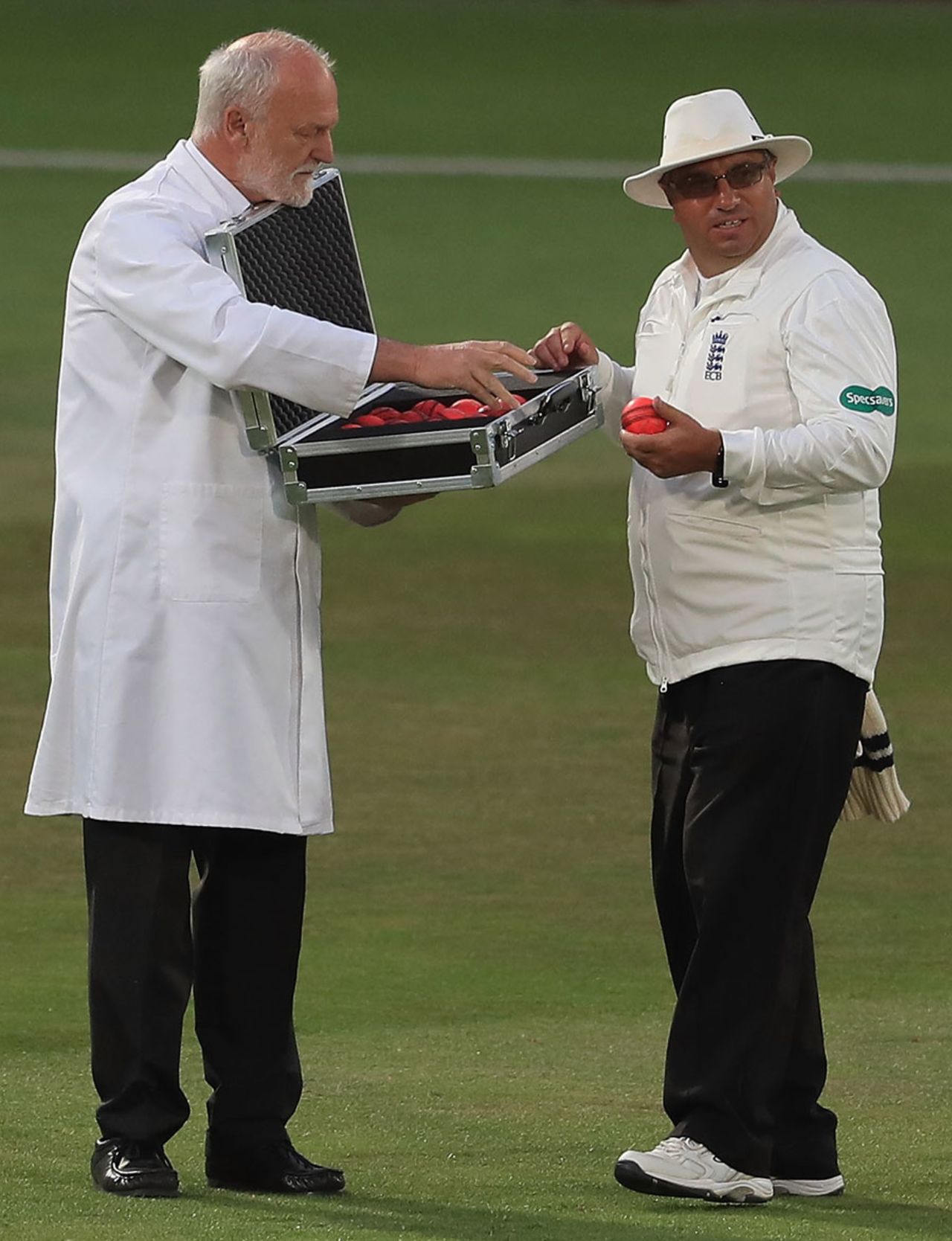 Umpire Neil Bainton selects a new pink ball from the box of replacements, Nottinghamshire v Kent, Specsavers County Championship Division One, Trent Bridge, 1st day, June 26, 2017