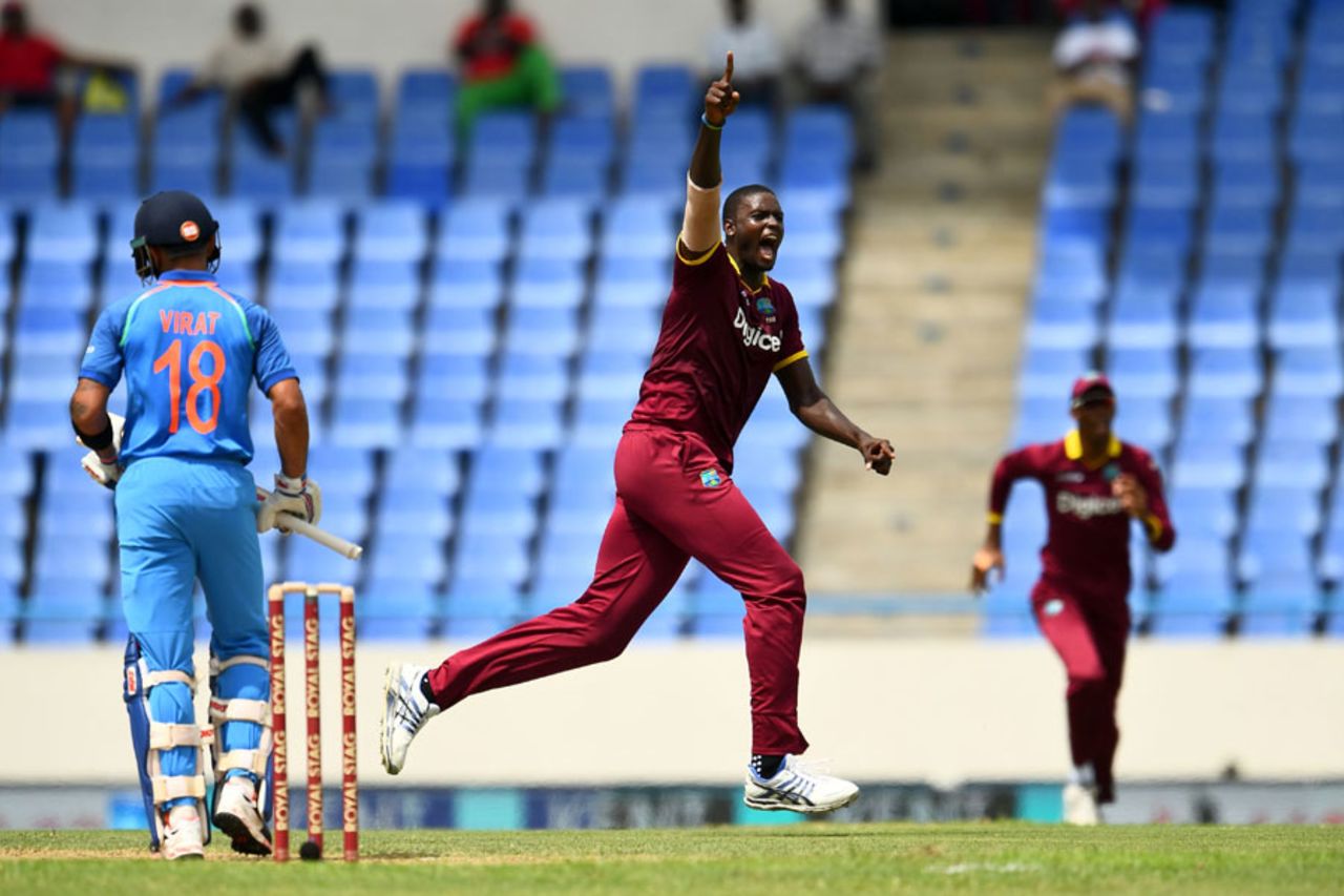 Jason Holder runs past Virat Kohli in celebration, West Indies v India, 3rd ODI, Antigua, June 30, 2017