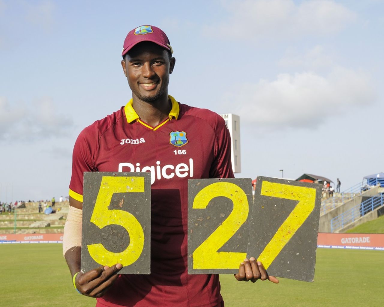 It's all mine: Jason Holder holds the scoring plates that shout out his best figures, West Indies v India, 4th ODI, Antigua, July 2, 2017