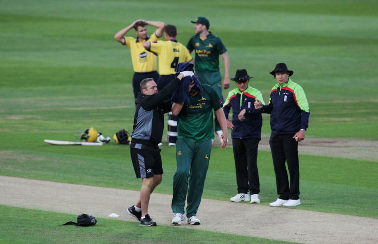 Luke Fletcher is helped from the field after being struck by the ball, Warwickshire v Nottinghamshire, NatWest Blast, North Group, Edgbaston