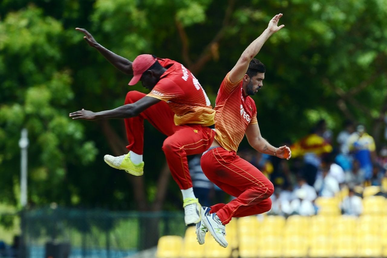 Graeme Cremer and Chris Mpofu take flight to celebrate a wicket, Sri Lanka v Zimbabwe, 5th ODI, Hambantota, July 10, 2017