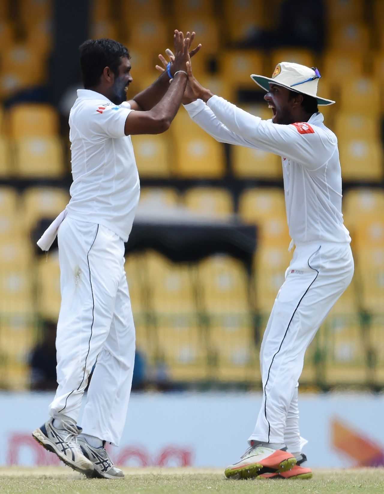 Dilruwan Perera celebrates a wicket with Dinesh Chandimal, Sri Lanka v Zimbabwe, only Test, 3rd day, Colombo, July 16, 2017