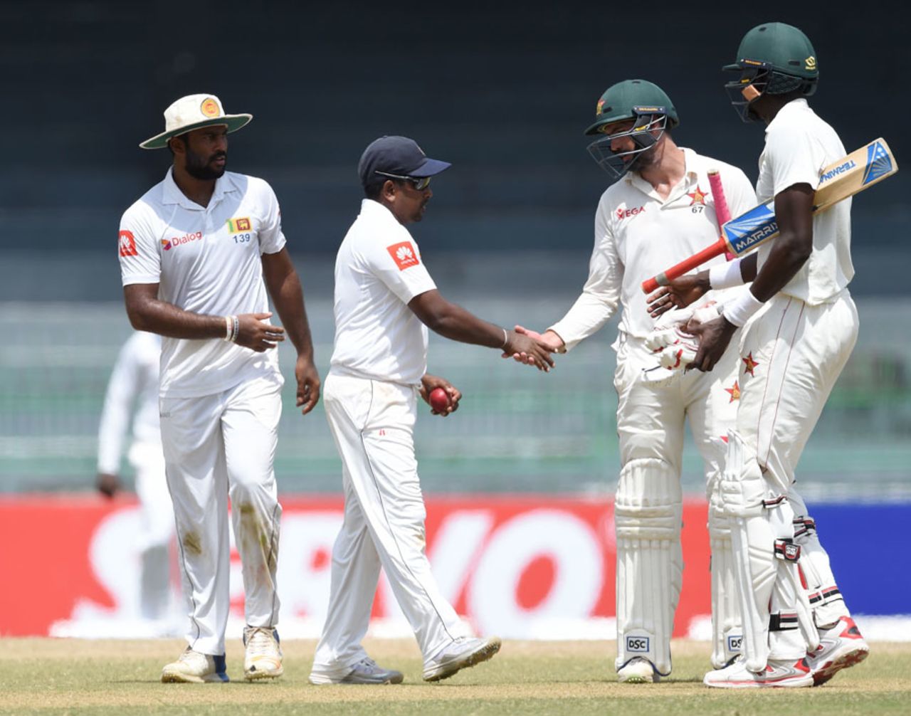 Graeme Cremer congratulates Rangana Herath on his 11-wicket haul, Sri Lanka v Zimbabwe, only Test, 4th day, Colombo, July 17, 2017