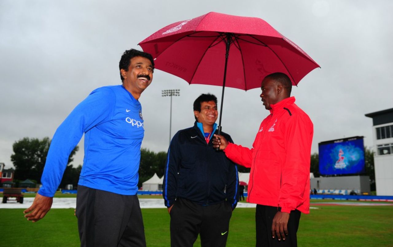 Reserve umpire Langston Rusere (right) and India coach Tushar Arothe (centre) chat about Derby's gloom, Australia v India, Women's World Cup, semi-final, Derby, July 20, 2017