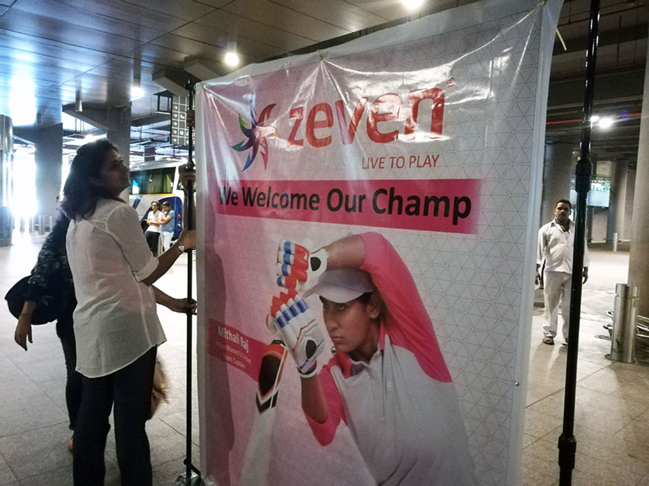 A sponsor's banner at the airport greets the women's team, Mumbai, July 26 2017