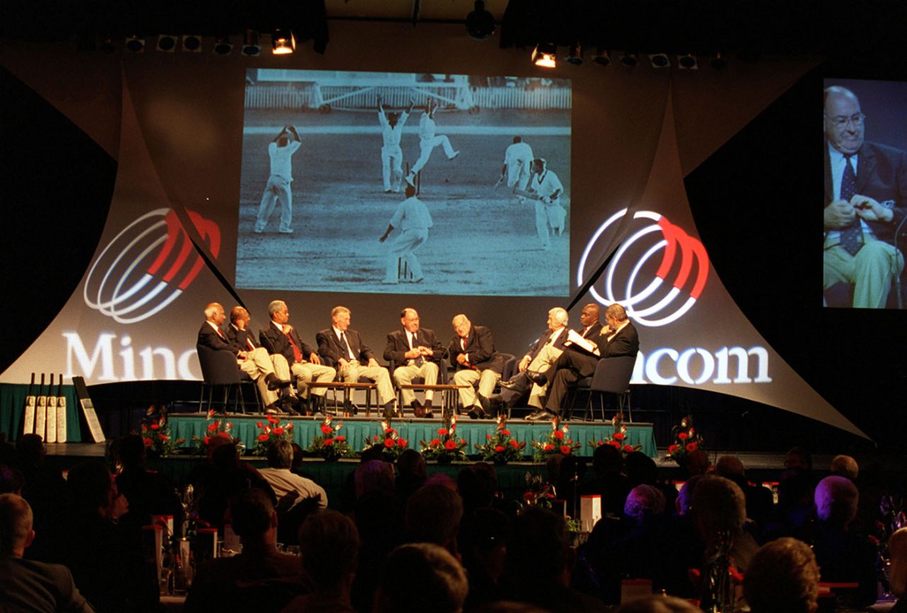 Players who figured in the 1960 tied Test in Brisbane sit on stage with a photograph of the final wicket from the game on a screen behind them at an event to mark the 40th anniversary of the match, Brisbane, November 21, 2000