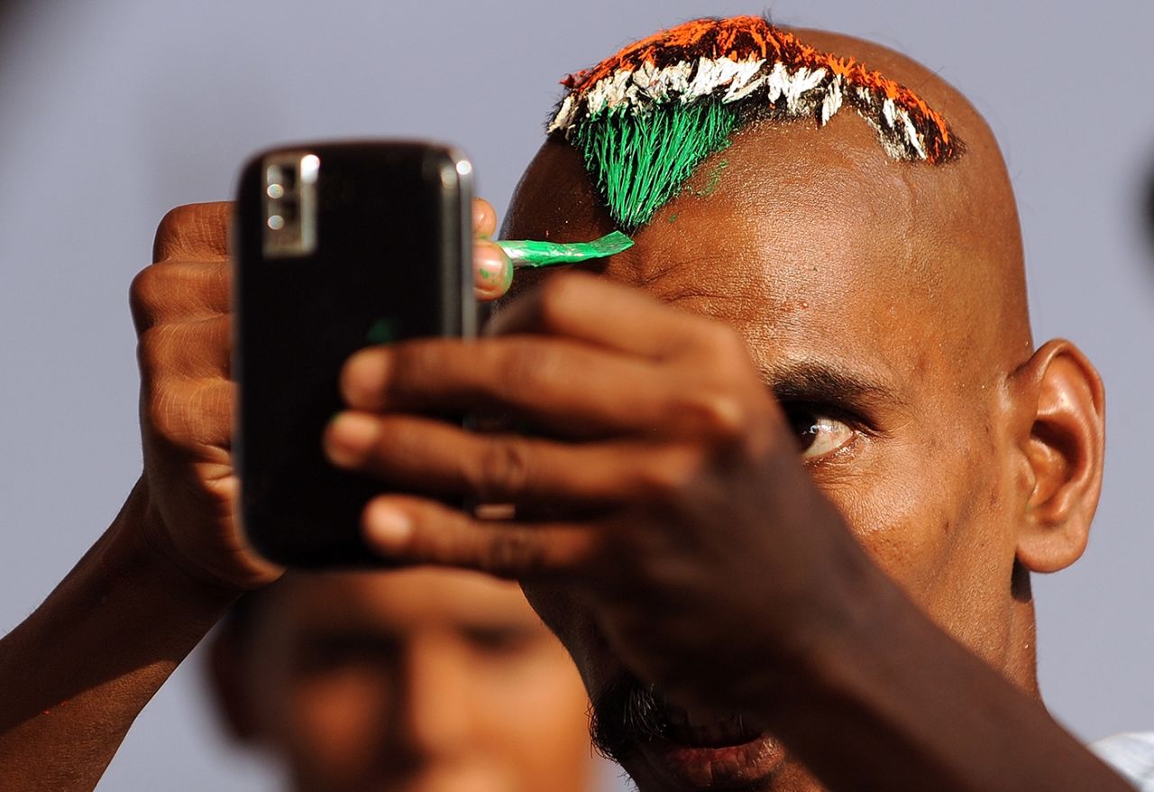 Sudhir Gautam paints the Indian tri-colour on his hair, Vadodara, December 3, 2010