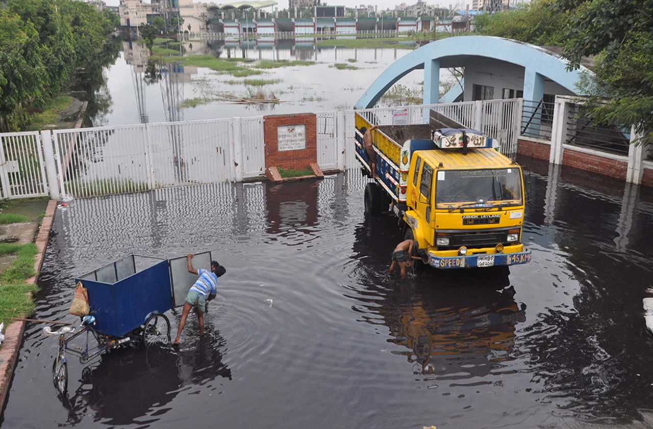 A truck and a delivery cycle are being washed with the contaminated water in front of the Fatullah Cricket Stadium's main gate, Fatullah, August 7