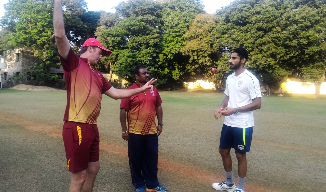 Glenn McGrath and MRF Pace Foundation's chief coach Myluahanan Senthilnathan talk to Punjab's Jaskaran Singh, 2017