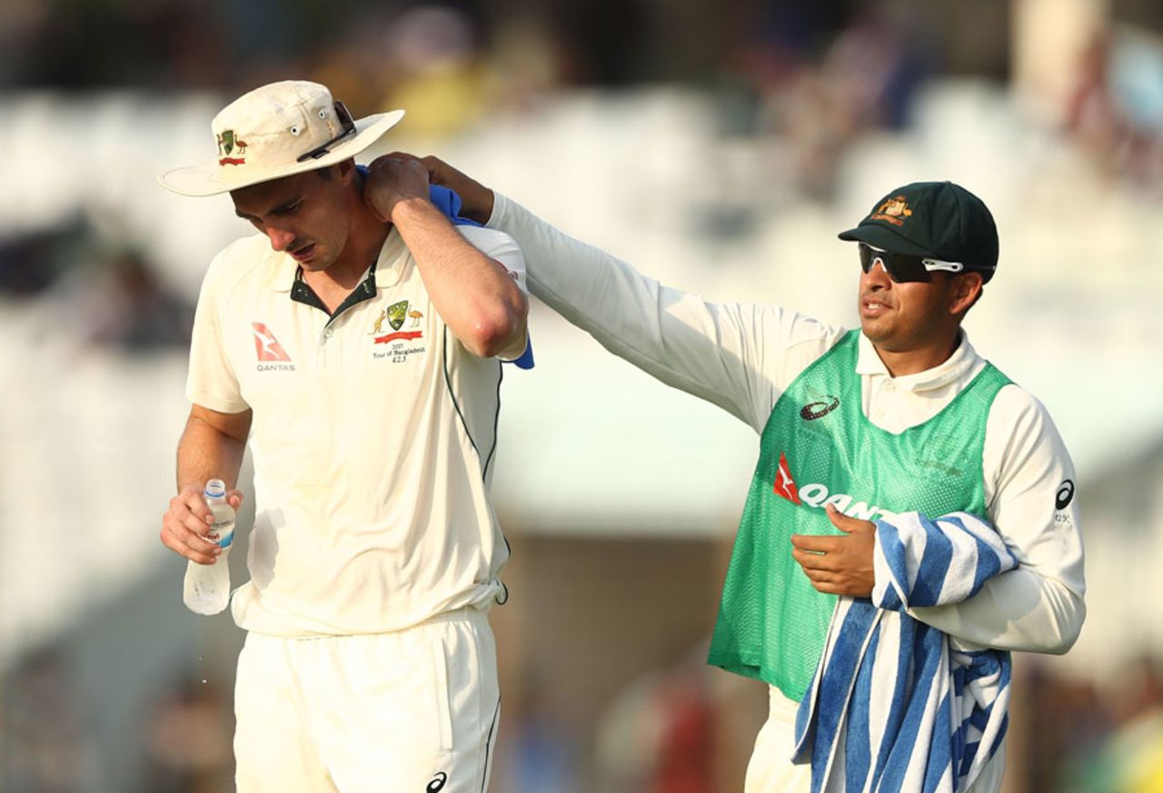 Pat Cummins gets his sore neck tended to by Usman Khawaja, Bangladesh v Australia, 2nd Test, Chittagong, 1st day, September 4, 2017