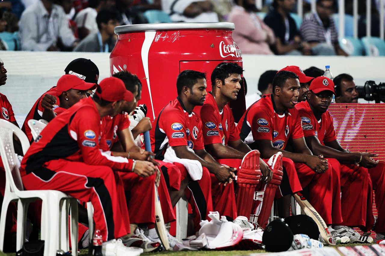 Daren Ganga (in pads) sits in the dugout with his team-mates after being run out, New South Wales v Trinidad & Tobago, Champions League Twenty20, League A, Hyderabad, October 16, 2009