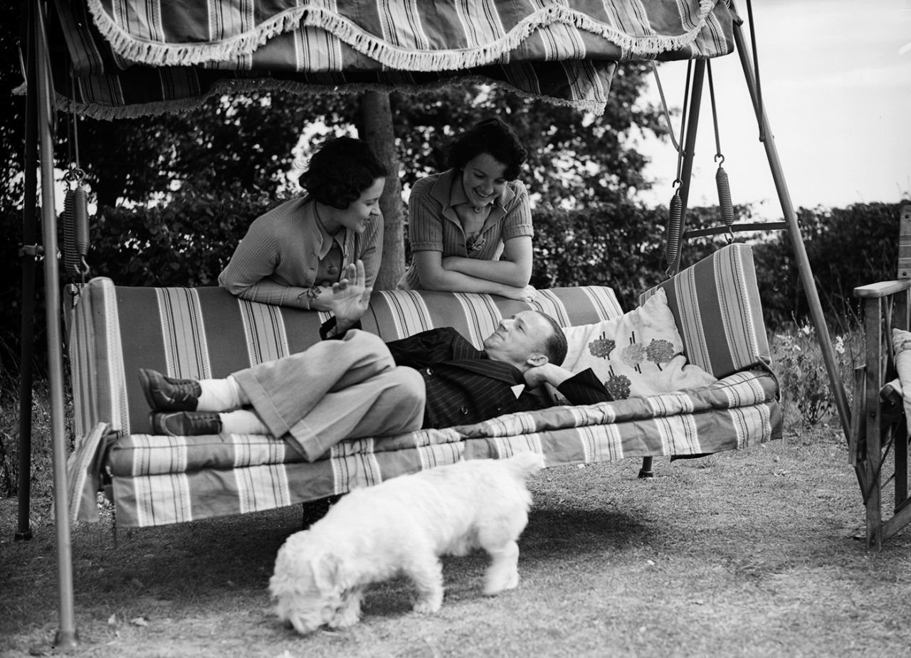 Don Bradman relaxes with his wife Jessie (right) in the home of his friend and England Test player Walter Robins and his wife (left) in Berkshire, 1938
