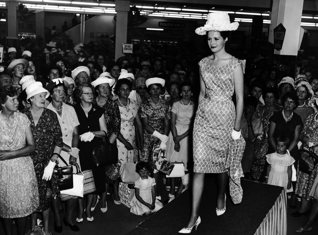 Susan Dexter, the wife of England captain Ted, models clothes in an Australian department store, November 1962