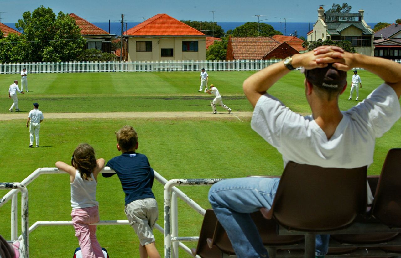 A couple of children and their father watch the cricket, University of New South Wales v Eastern SUburbs, Waverly Oval, Sydney, November 6, 2004