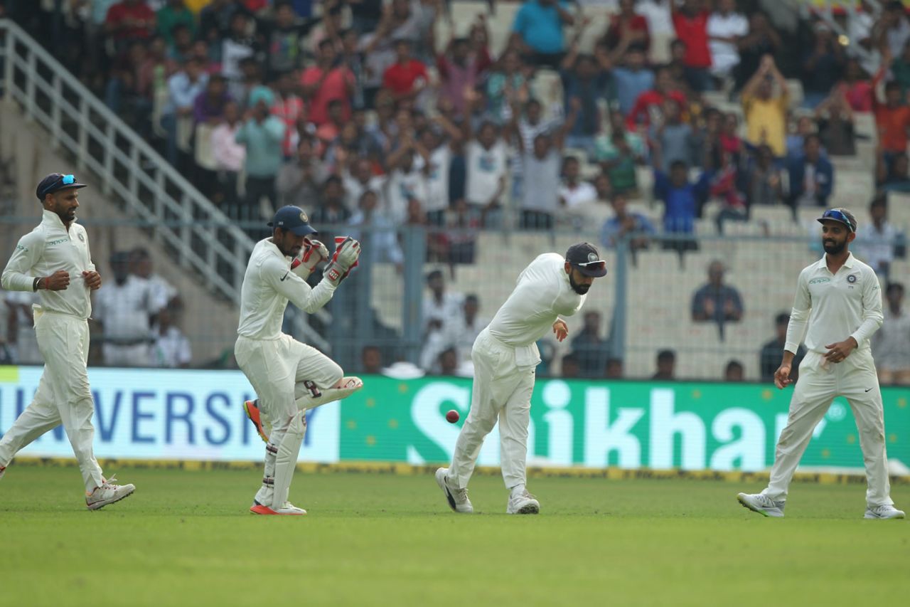 Virat Kohli chucks the ball into the turf to celebrate a catch, India v Sri Lanka, 1st Test, 3rd Day, Kolkata, 18 November, 2017