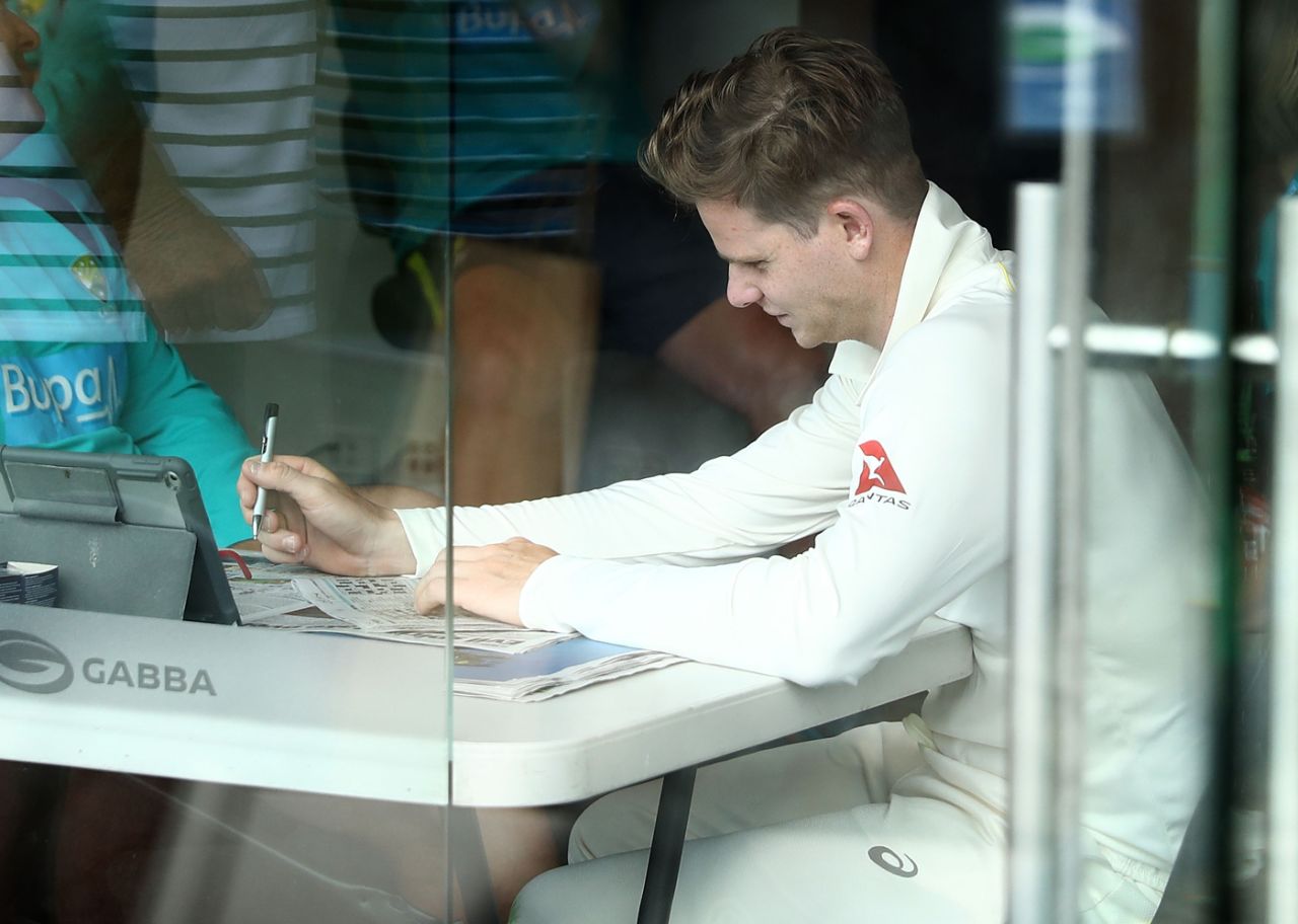 Steven Smith keeps himself occupied with some crossword-solving during the rain interruption, Australia v England, 1st Test, The Ashes 2017-18, 1st day, Brisbane, November 23, 2017