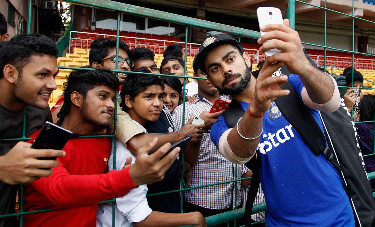 Virat Kohli takes a selfie with excited fans during a practice session, Bangalore, Novmeber 12, 2015