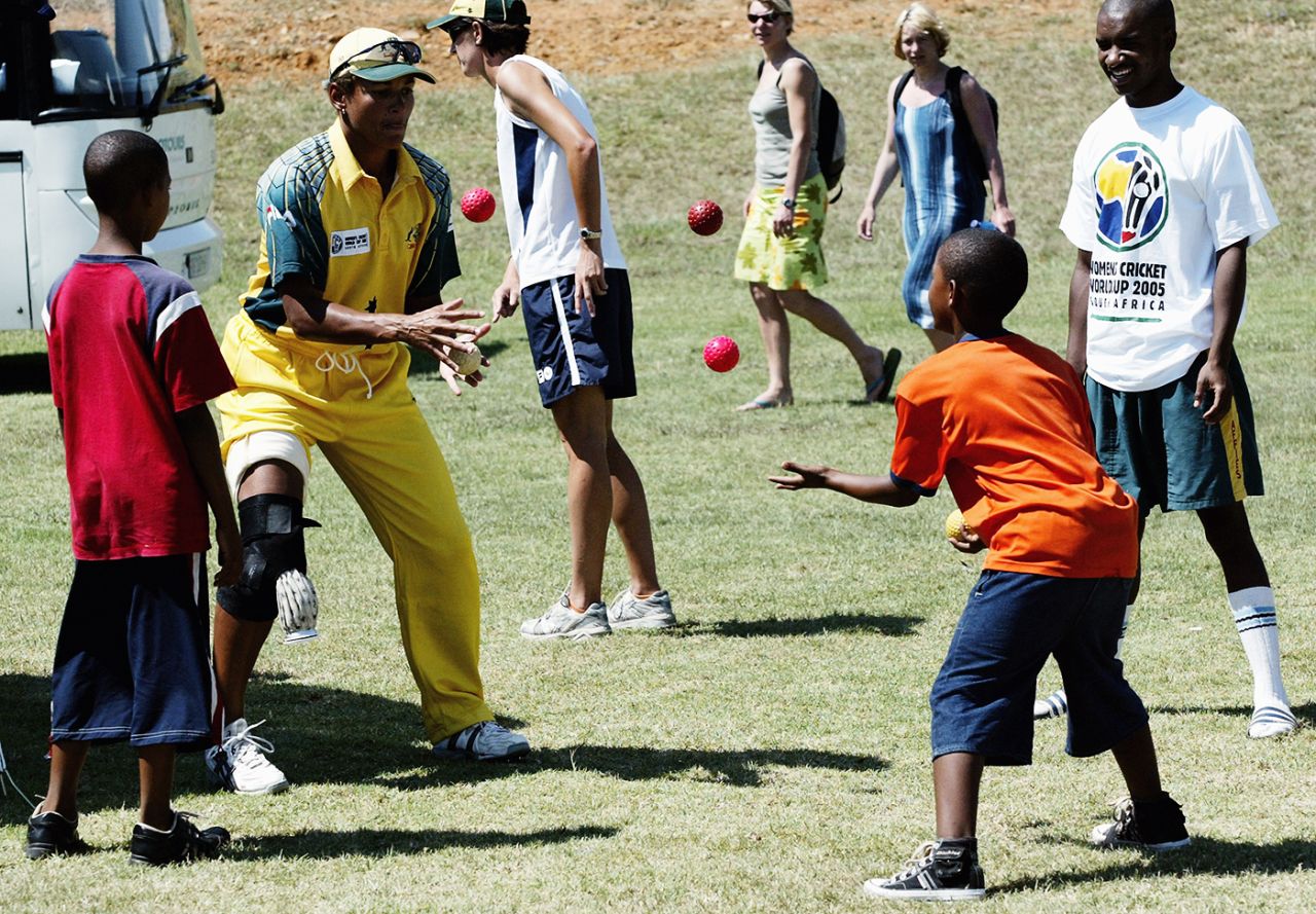 Australia's Mel Jones plays catch with kids ahead of the World Cup game in Pretoria, April 1, 2005