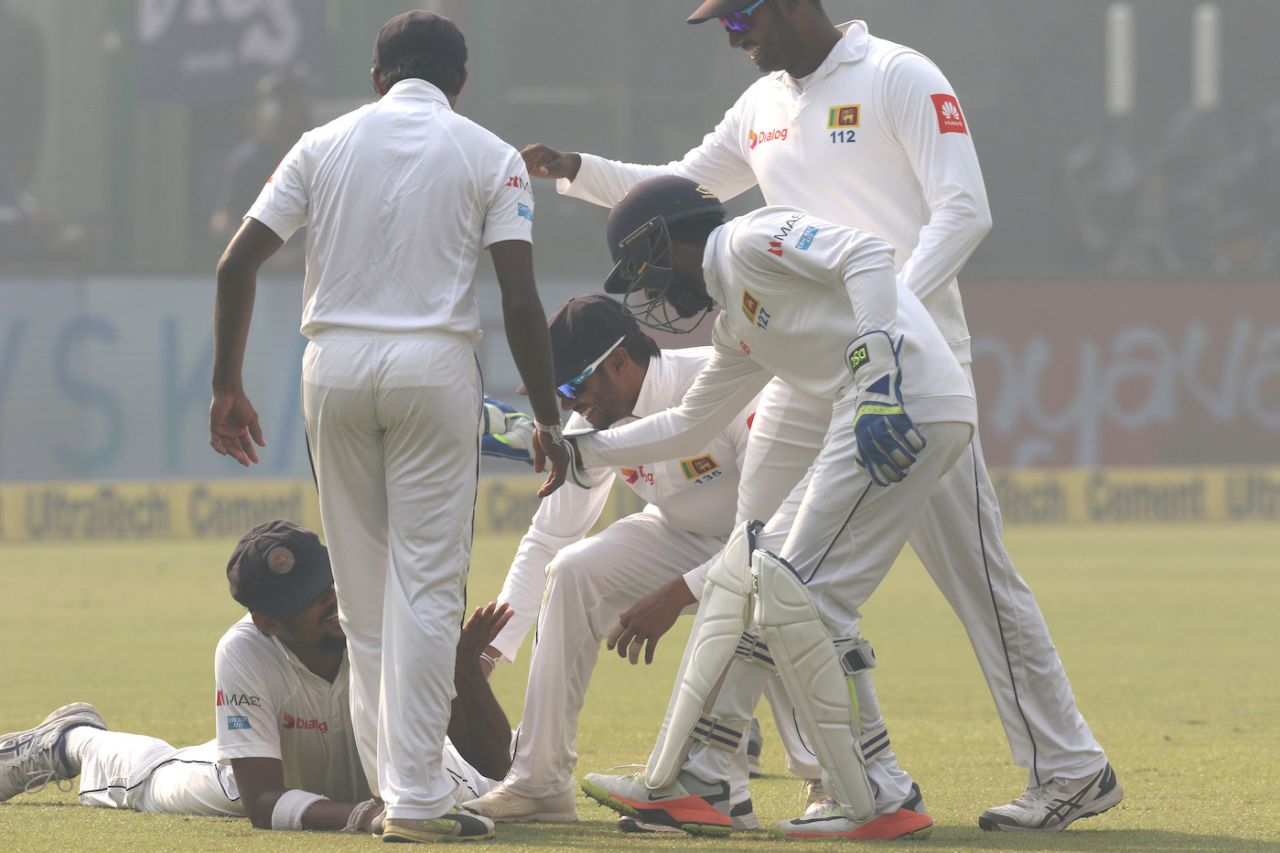 Suranga Lakmal is mobbed by team-mates after taking an unusual catch, India v Sri Lanka, 3rd Test, Delhi, 1st day, December 2, 2017
