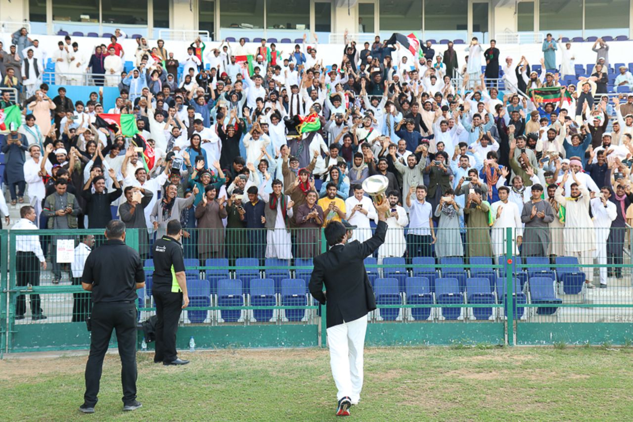 Captain Asghar Stanikzai walks the Intercontinental Cup over to the Afghanistan fans, UAE v Afghanistan, 2015-17 Intercontinental Cup, 4th day, Abu Dhabi, December 2, 2017