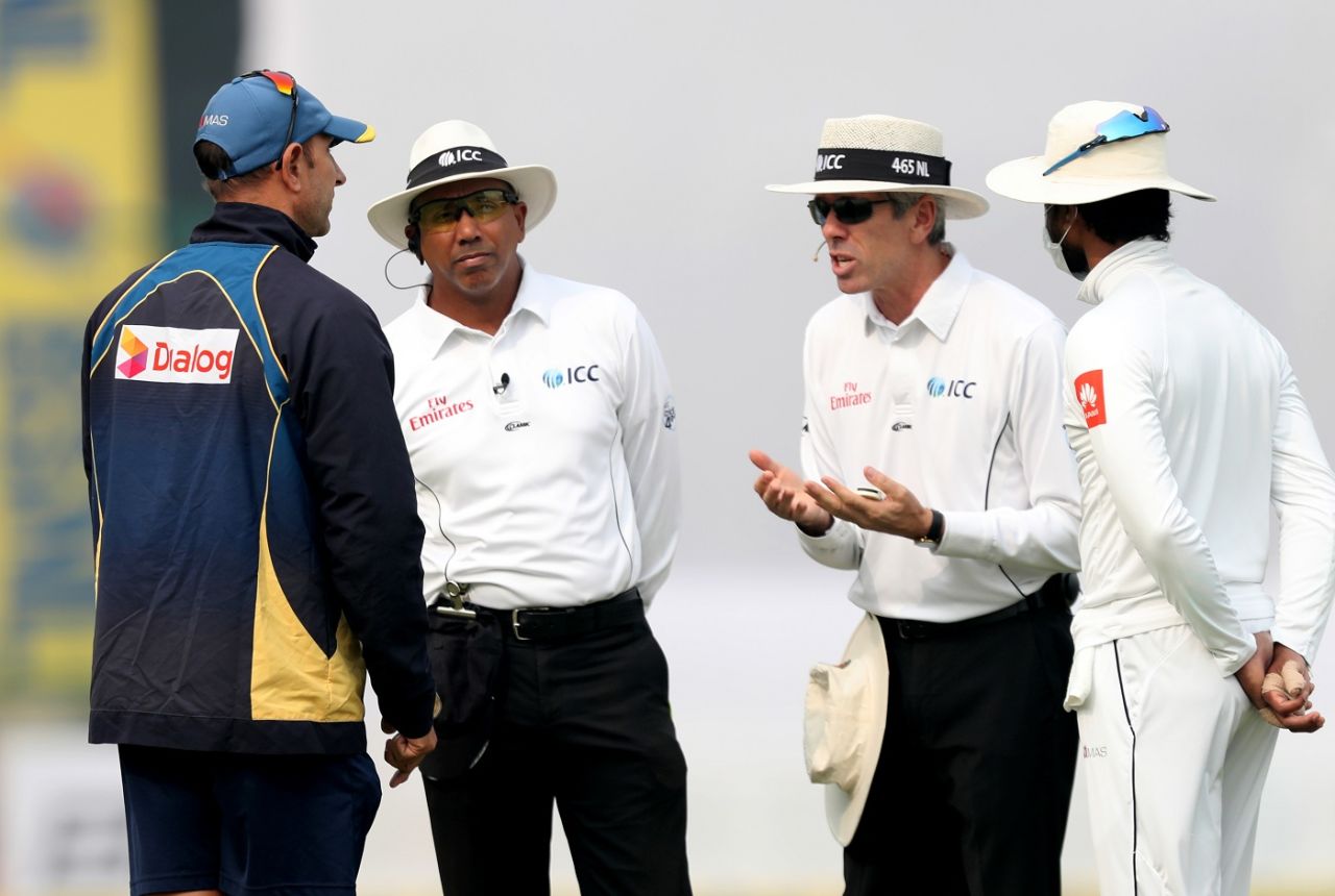 Sri Lanka coach Nic Pothas and captain Dinesh Chandimal have a chat with the umpires as bad weather stops play, India v Sri Lanka, 3rd Test, Delhi, 2nd day, December 3, 2017