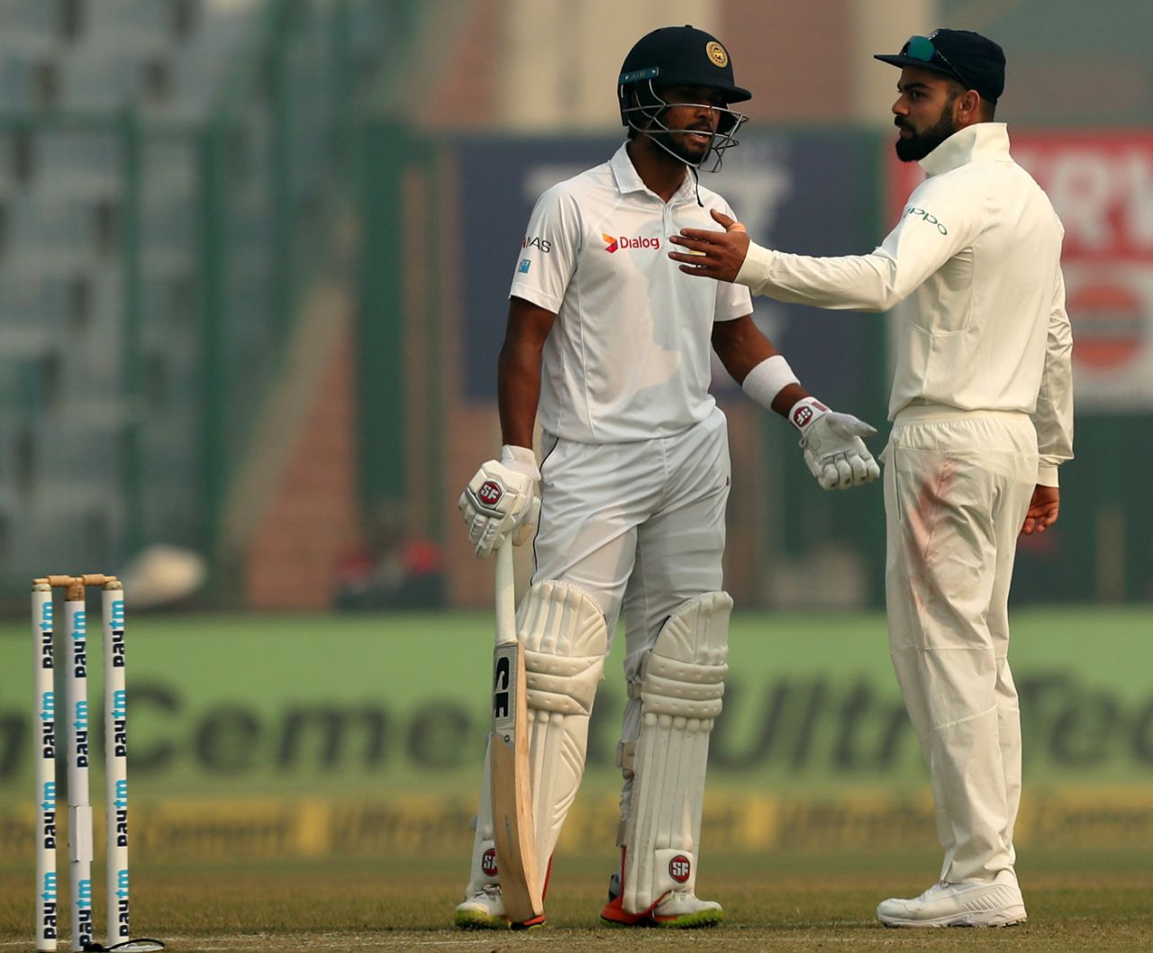 Dinesh Chandimal and Virat Kohli had an animated chat after the Sri Lanka physio was summoned onto the field, India v Sri Lanka, 3rd Test, Delhi, 3rd day, December 4, 2017