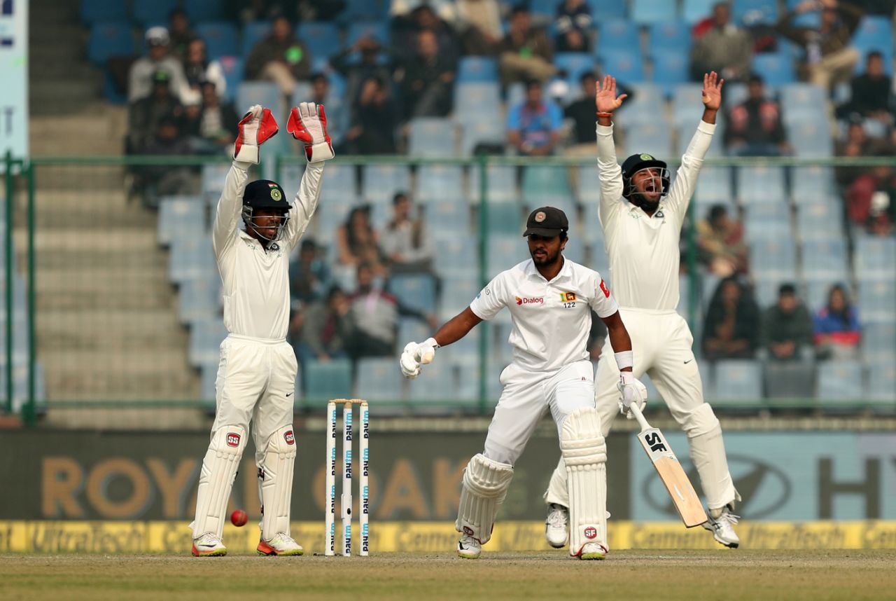 Wriddhiman Saha and Cheteshwar Pujara appeal unsuccessfully for the wicket of Dinesh Chandimal, India v Sri Lanka, 3rd Test, Delhi, 3rd day, December 4, 2017