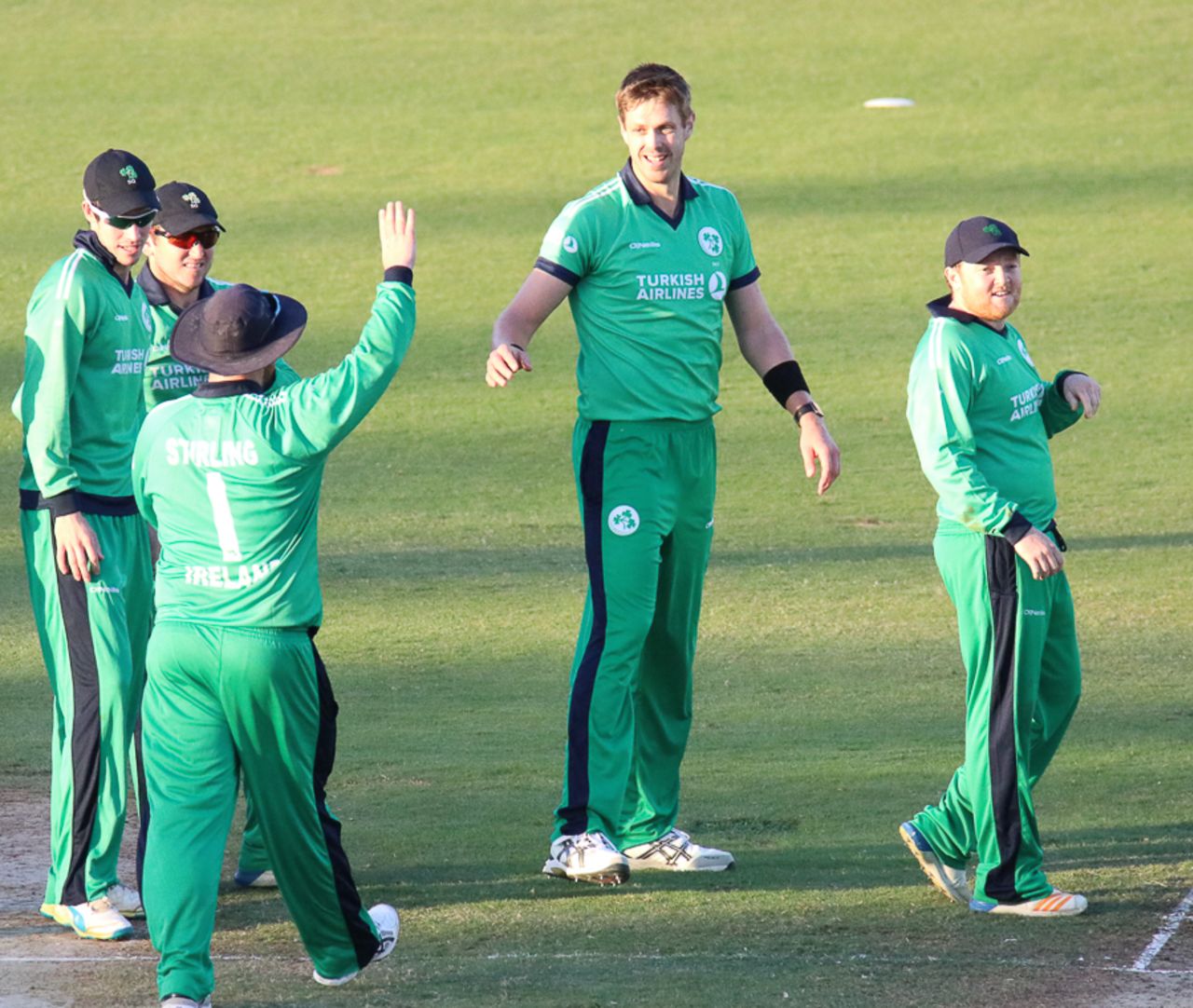 Boyd Rankin gets a high five from Paul Stirling after taking his third wicket, Afghanistan v Ireland, 1st ODI, Sharjah, December 5, 2017