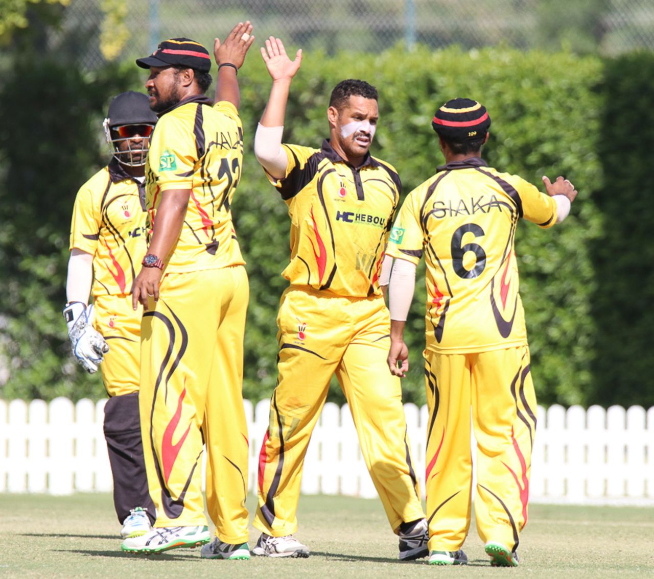 Chad Soper gets a high five from captain Assad Vala and Lega Siaka after taking a wicket, Hong Kong v Papua New Guinea, 1st ODI, 2015-17 WCL Championship, Dubai, December 6, 2017