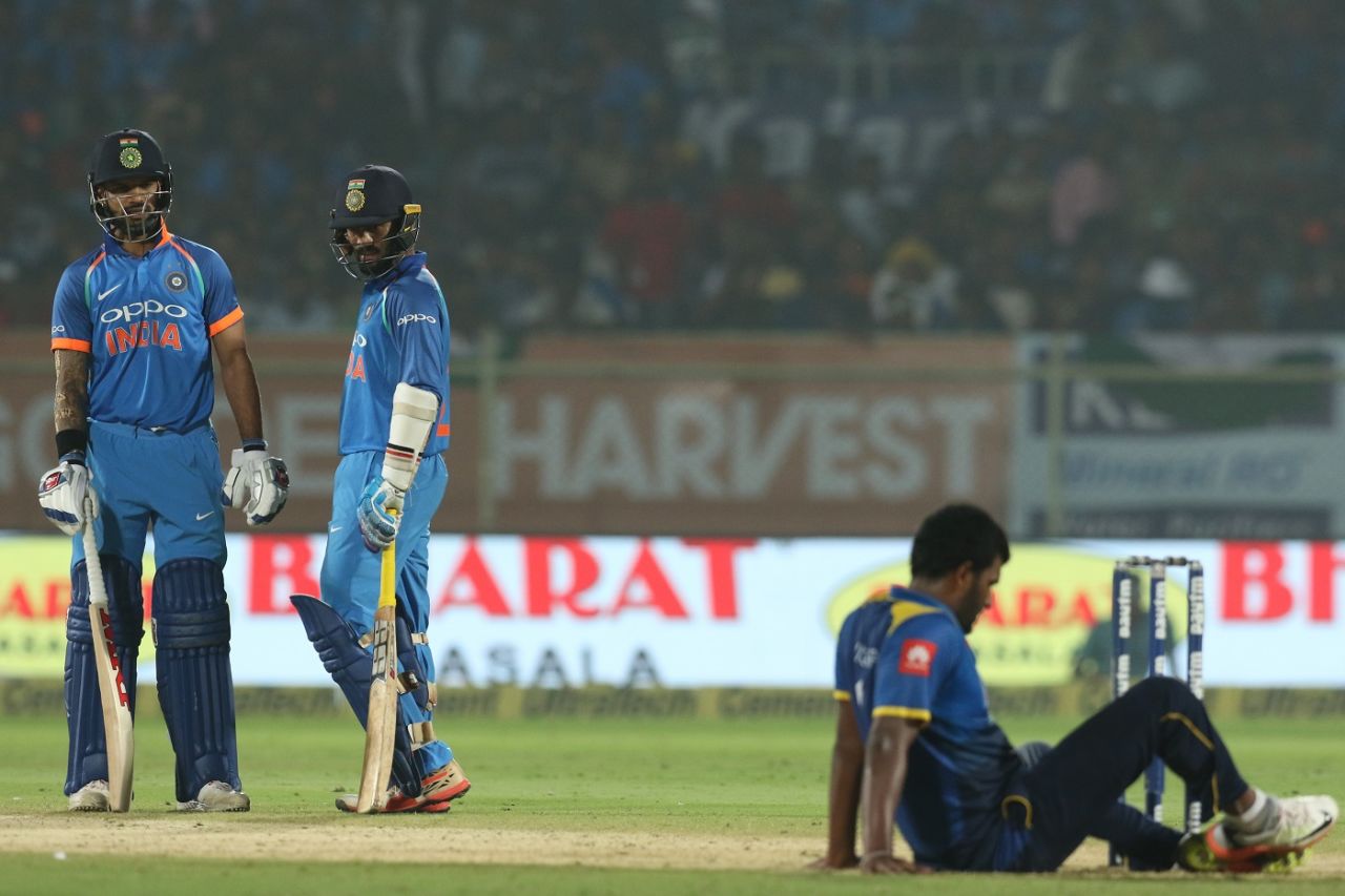 Shikhar Dhawan and Dinesh Karthik look on as Thisara Perera takes a fall, India v Sri Lanka, 3rd ODI, Visakhapatnam, December 17, 2017