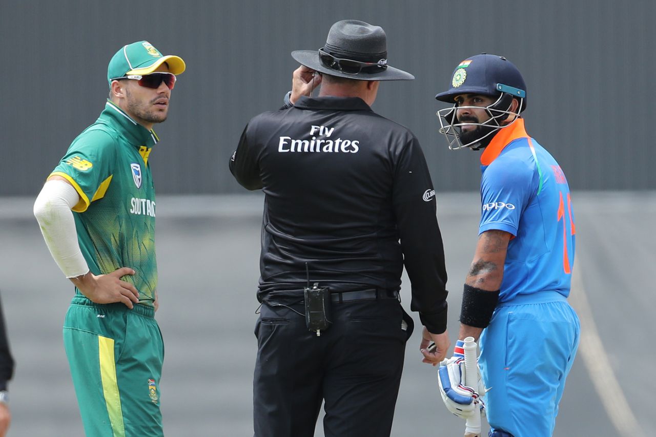 Virat Kohli and Aiden Markram chat with the umpire as lunch is called with India needing two runs to win, South Africa v India, 2nd ODI, Centurion, February 4, 2018 