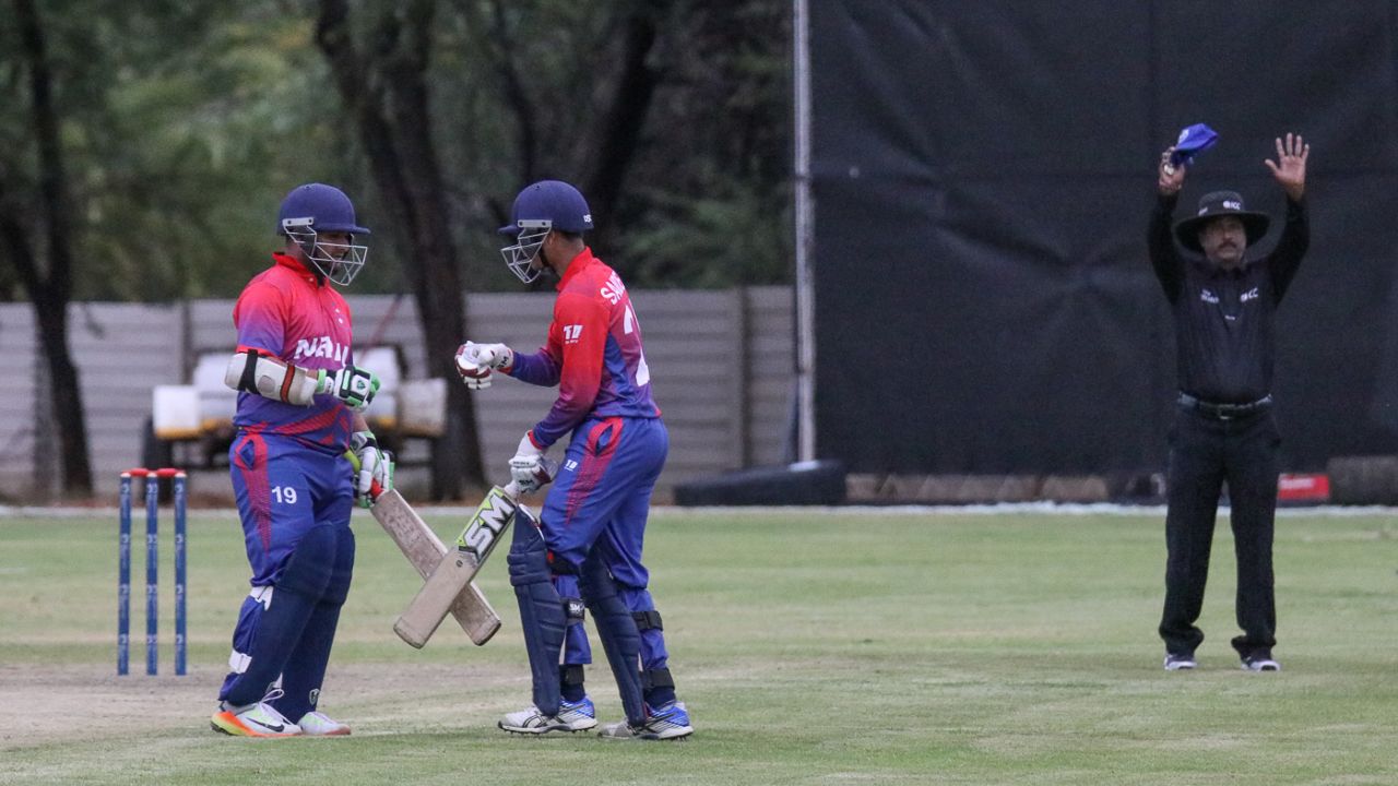 Basant Regmi punches gloves with Sandeep Lamichhane after smashing a crucial six, Namibia v Nepal, ICC World Cricket League Division Two, Windhoek, February 8, 2018
