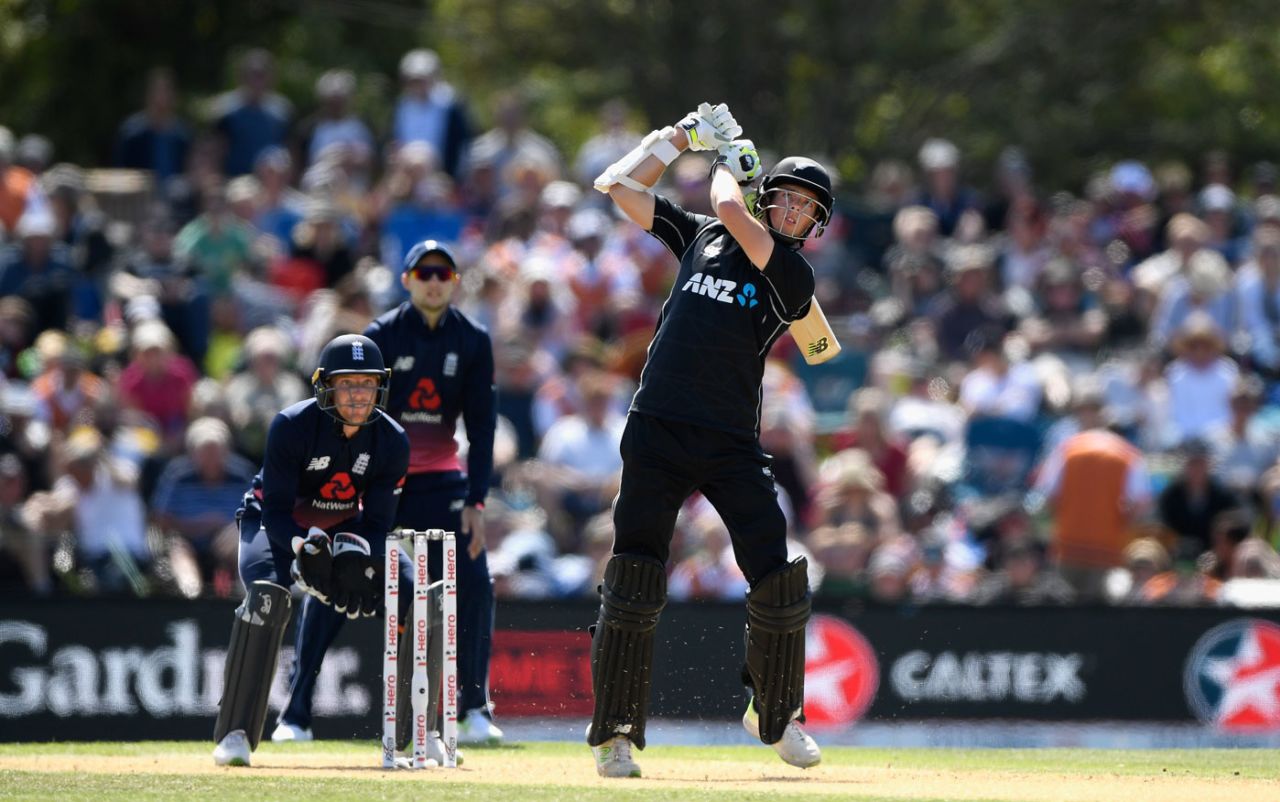 Mitchell Santner steps out to hit down the ground, New Zealand v England, 5th ODI, Christchurch, March 10, 2018