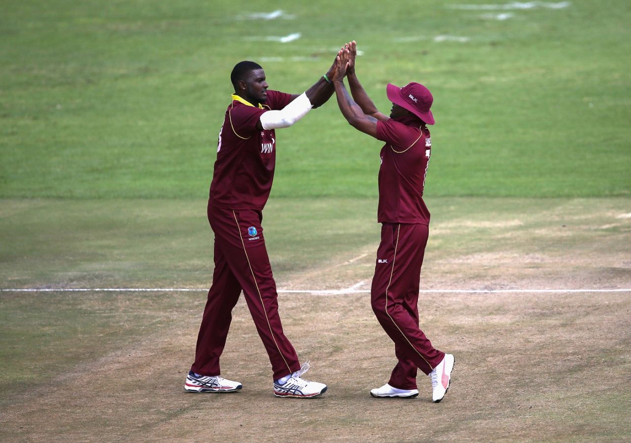 Jason Holder and Marlon Samuels get together to celebrate a wicket, West Indies v Afghanistan, World Cup Qualifiers, Super Six stage, March 15, 2018