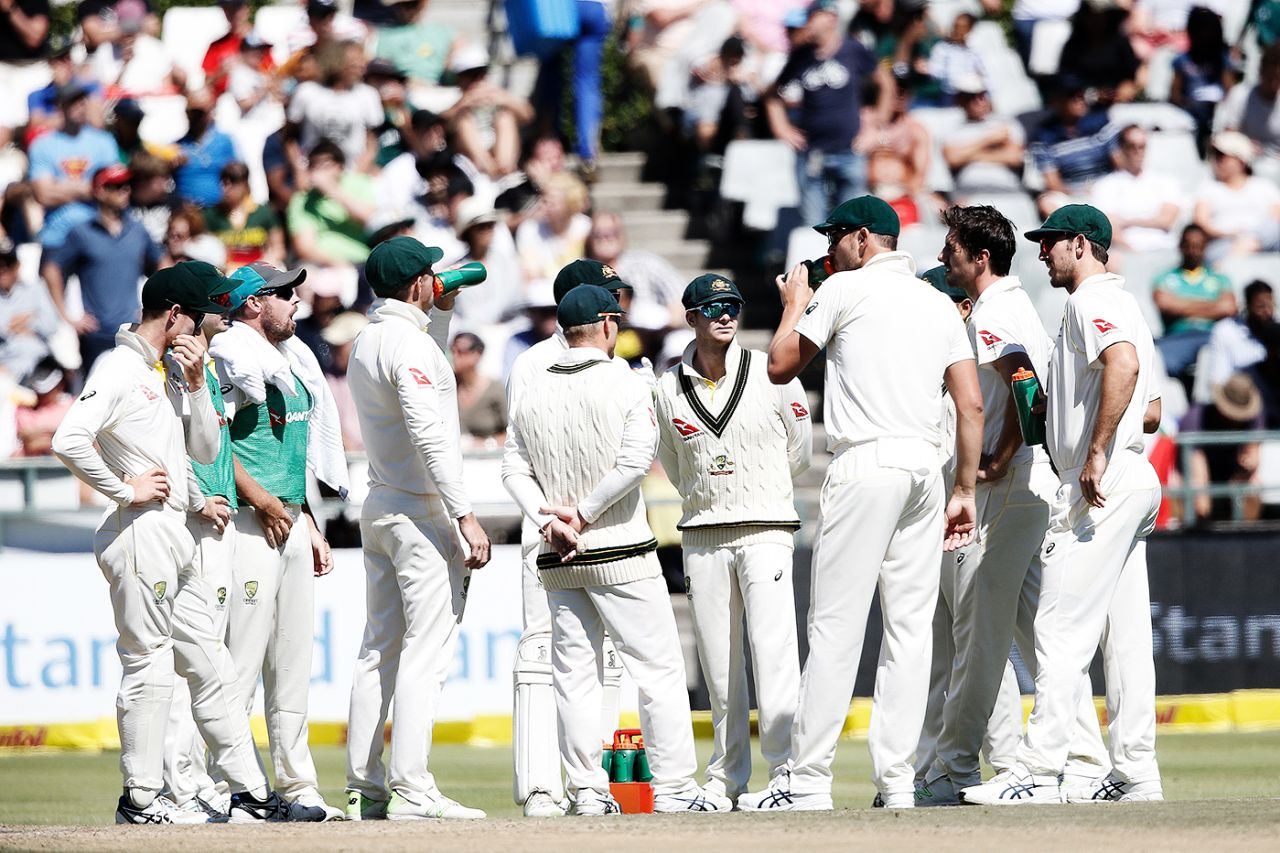 Australian players huddle for a drink a day after they were found tampering with the ball, South Africa v Australia, 3rd Test, Cape Town, 4th day, March 25, 2018