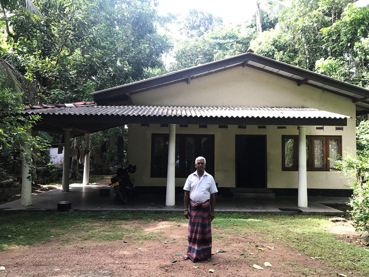 Lasith Malinga's father, S Milton, in front of the family home in Rathgama