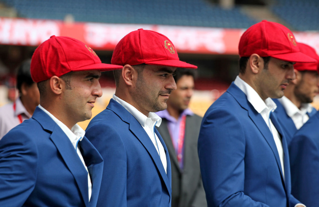 The Afghanistan players, including Rashid Khan and Mohammad Nabi don their maiden Test caps, India v Afghanistan, Only Test, Bengaluru, 1st day, June 14, 2018