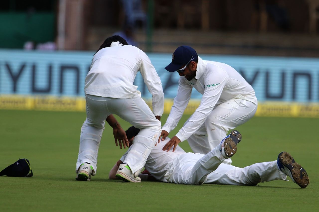 Karun Nair and M Vijay congratulate a prone Ishant Sharma after a catch. India v Afghanistan, Only Test, Bengaluru, 2nd day, June 15, 2018