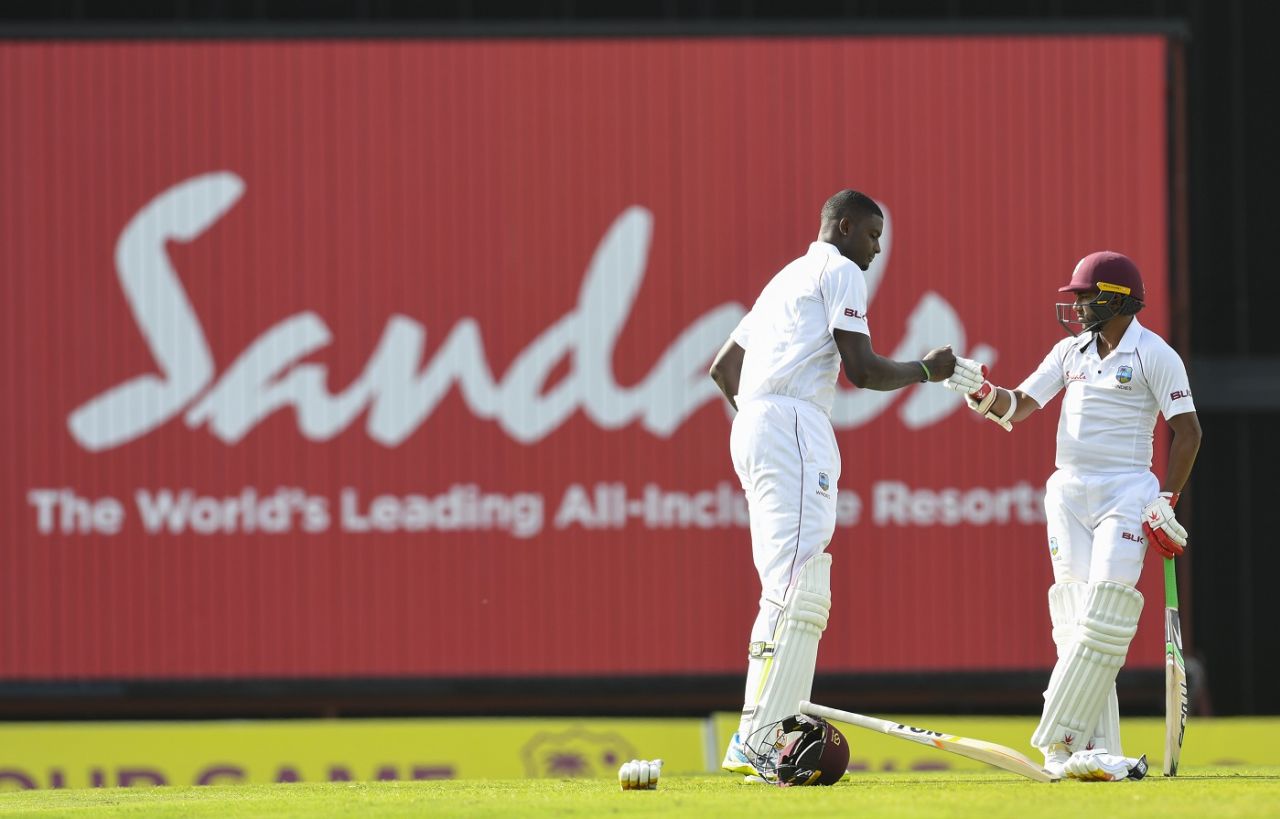 Jason Holder and Shane Dowrich punch gloves during their century stand. West Indies v Sri Lanka, 3rd Test, Bridgetown, 2nd day, June 24, 2018