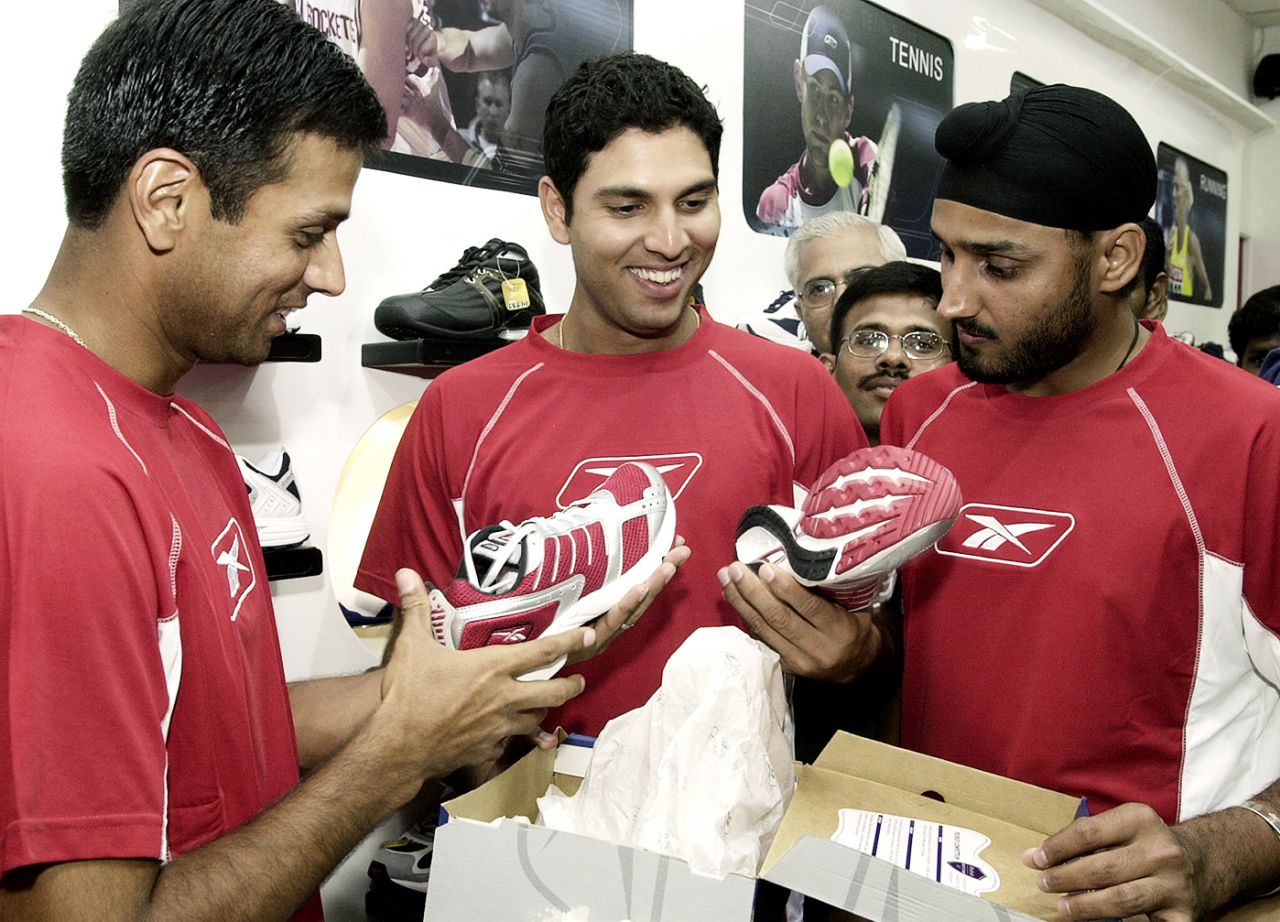 Rahul Dravid, Yuvraj Singh and Harbhajan Singh look at new shoes at a shoe store in Chennai, July 7, 2004