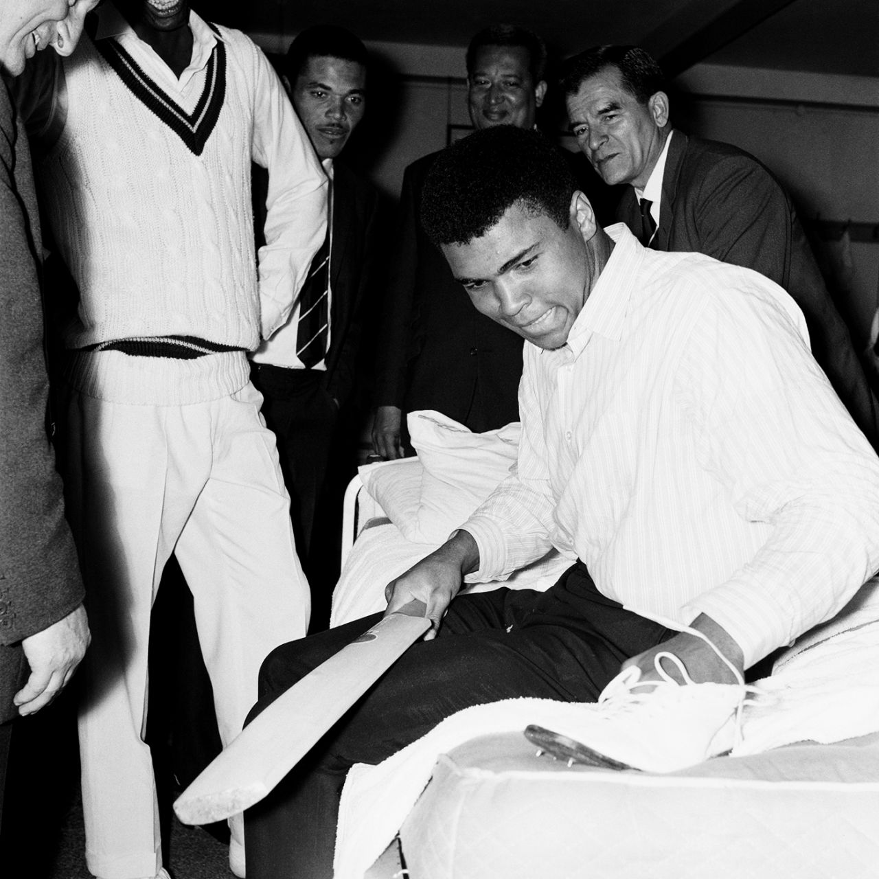 Muhammad Ali examines a cricket boot in the West Indies dressing room at Lord's, England v West Indies, Lord's, 1st day, June 16, 1966