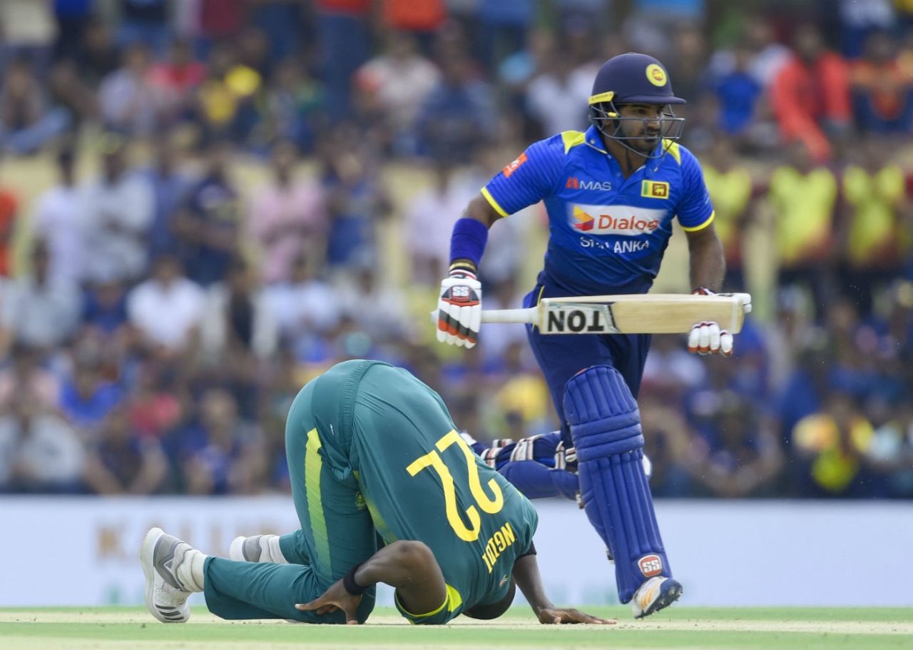 Lungi Ngidi tumbles in his followthrough as Kusal Perera steals a run, Sri Lanka v South Africa, 1st ODI, Dambulla, July 29, 2018