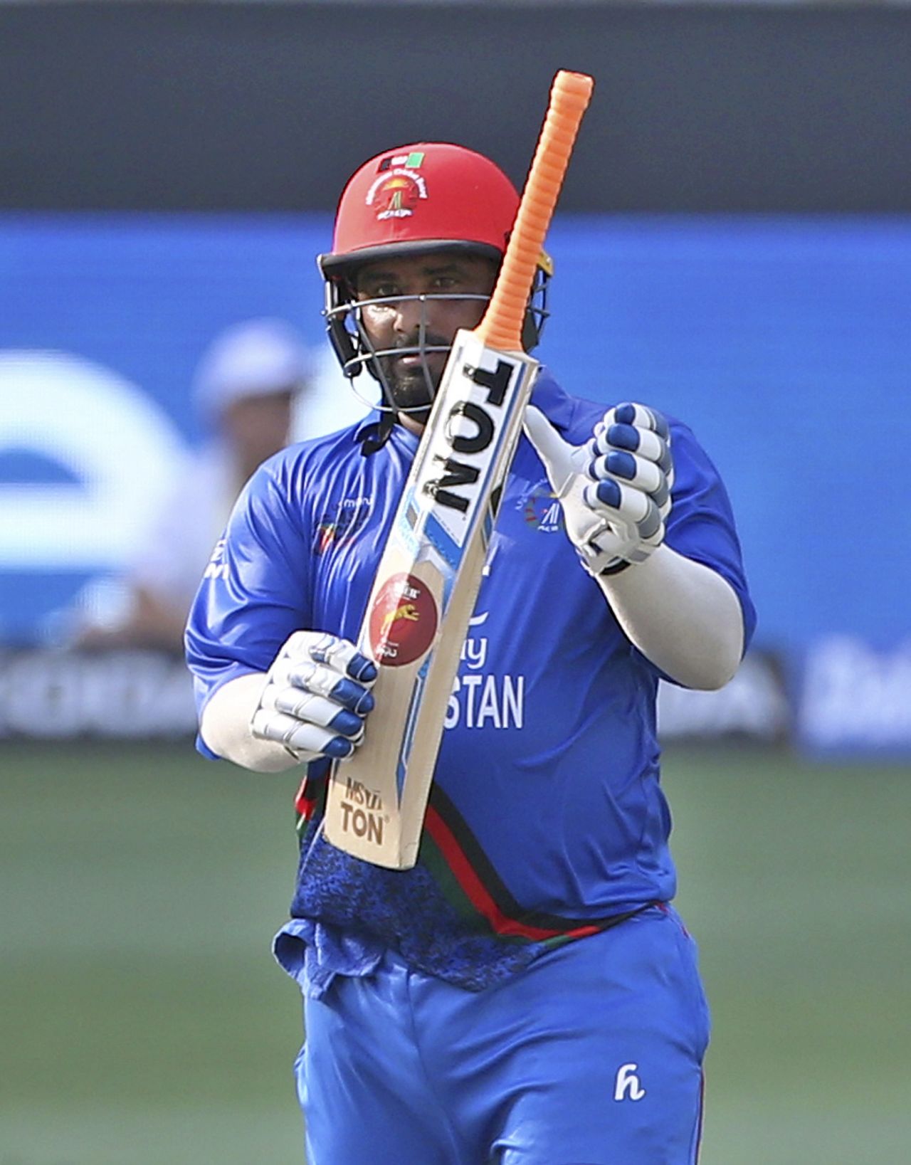 Mohammad Shahzad points to his bat after completing his 14th ODI fifty, Afghanistan v India, Asia Cup 2018, Dubai, September 25, 2018