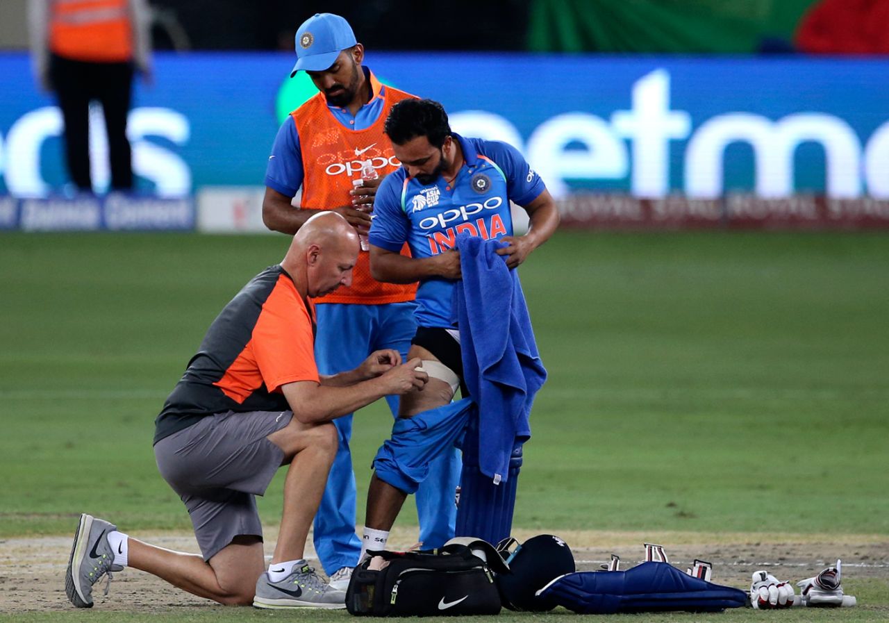 KL Rahul looks on as India physio Patrick Farhart attends to Kedar Jadhav's hamstrings, Bangladesh v India, Asia Cup final, Dubai, September 28, 2018