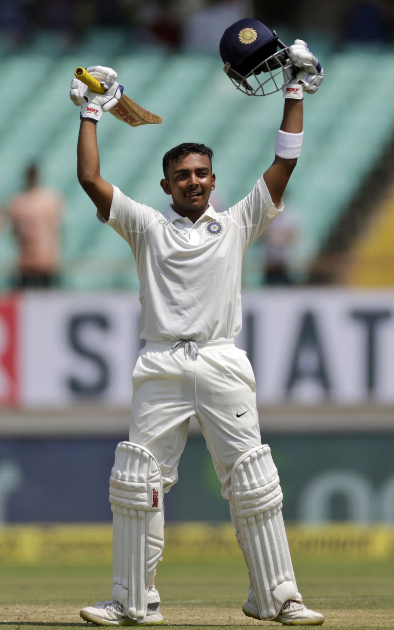 Prithvi Shaw raises his bat after a century on debut, India v West Indies, 1st Test, Rajkot, 1st day, October 4, 2018